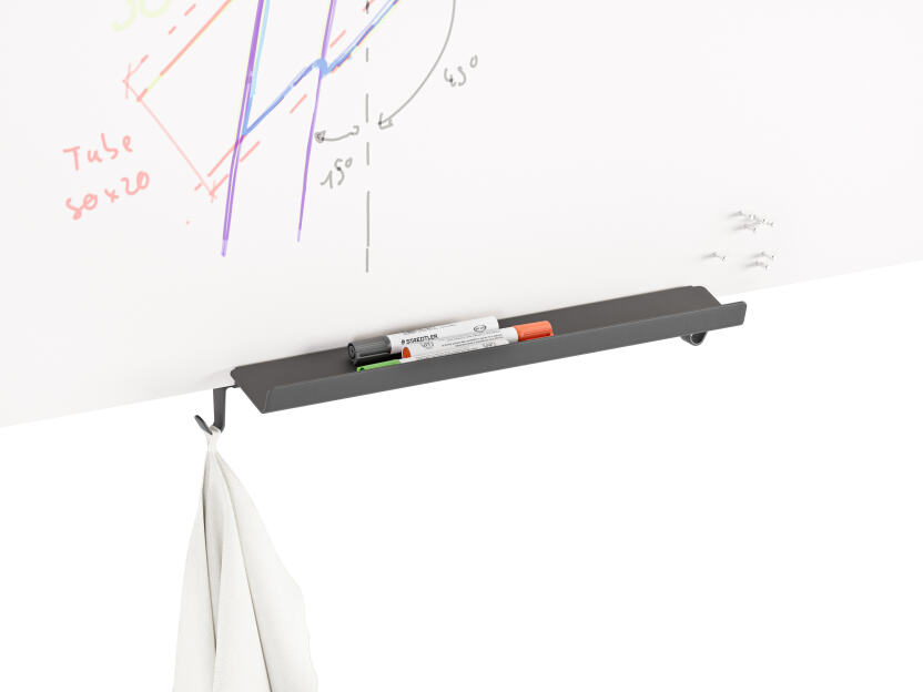 Black aluminium tray mounted to the bottom of a whiteboard that holds three markers and a cleaning cloth designed by Michel Charlot for FAUST Linoleum