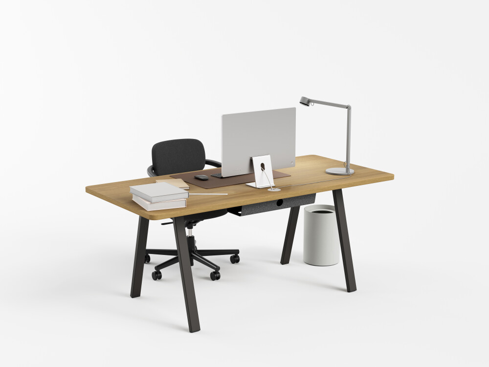 DIN PLUS desk by Faust with oak top and black metal frame, equipped with computer and office supplies.