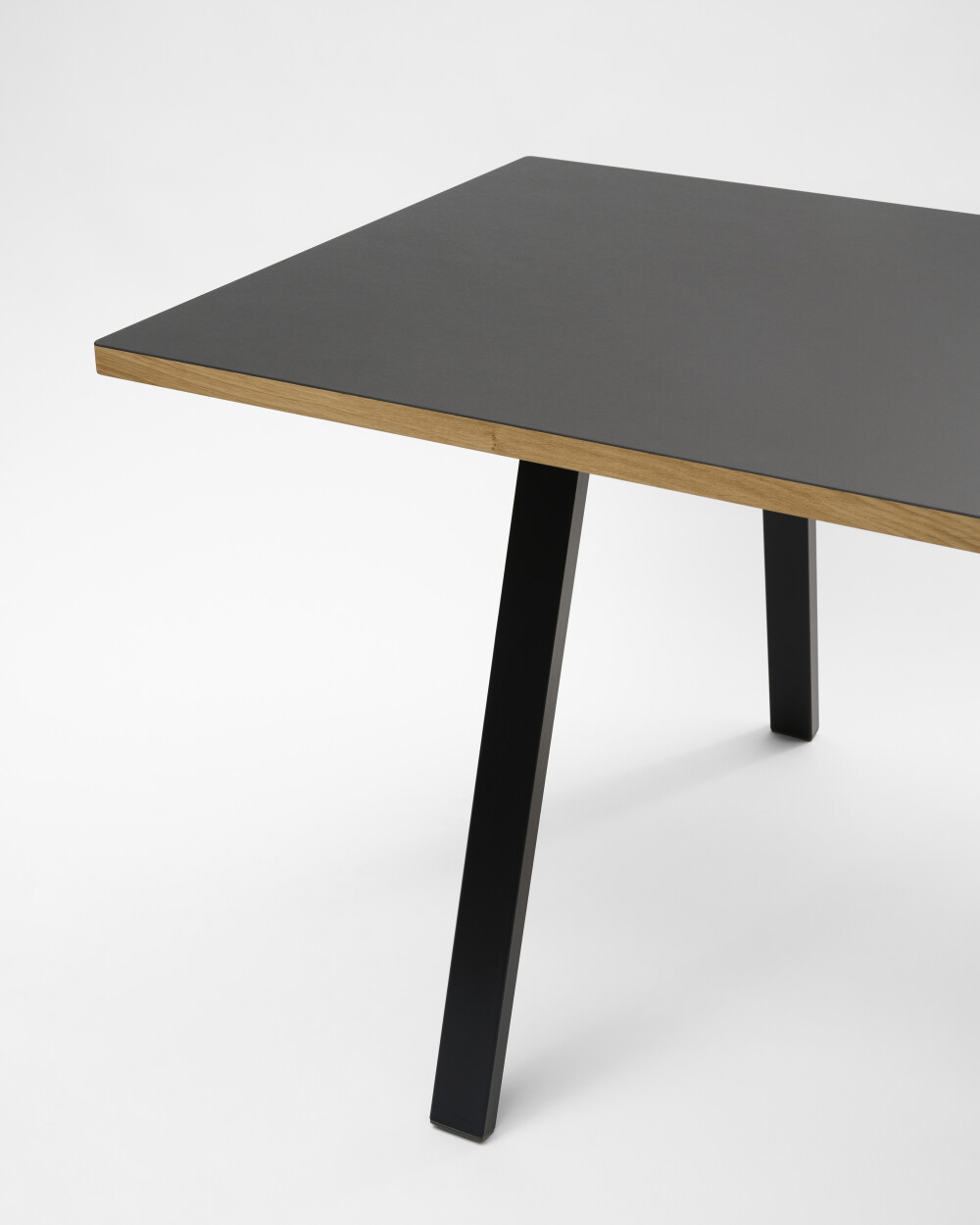 Rectangular DIN PLUS table leg by Faust, made of black powder-coated metal, and linoleum table top against a white background.