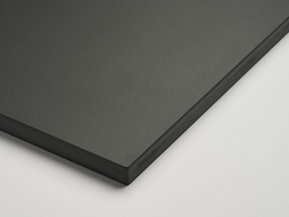 Close-up of an anthracite gray Faust table top with linoleum surface in Charcoal and visible MDF edge.