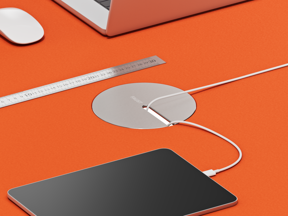 Round flip cable cover made of aluminum and linoleum, embedded in a linoleum tabletop.