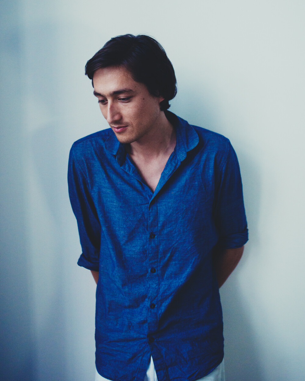 Portrait of Daniel Lorch - Berlin industrial designer and long-standing cooperation partner of Faust, photographed in the studio against a light background.