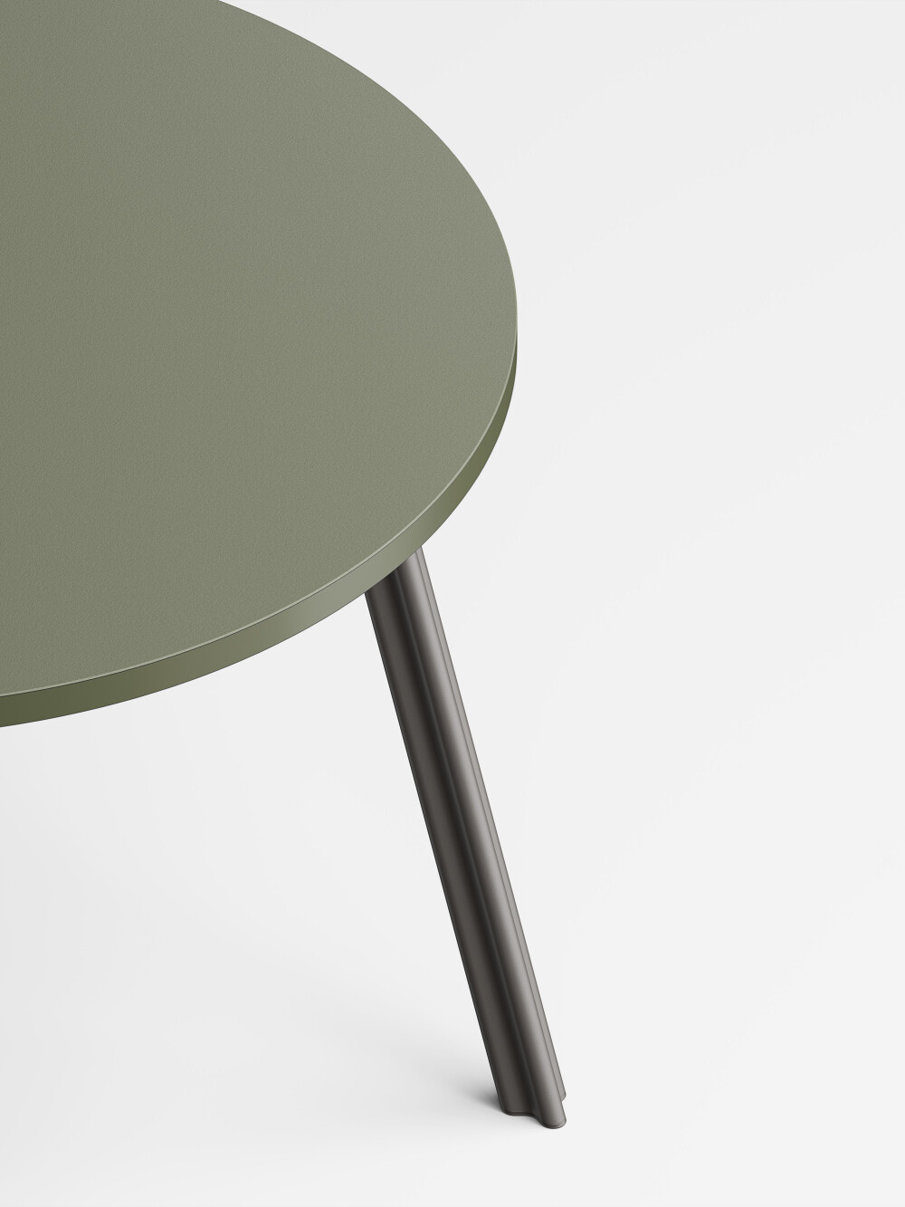 Close-up of the Beam Table Leg M in black grey aluminum on a grey linoleum tabletop.