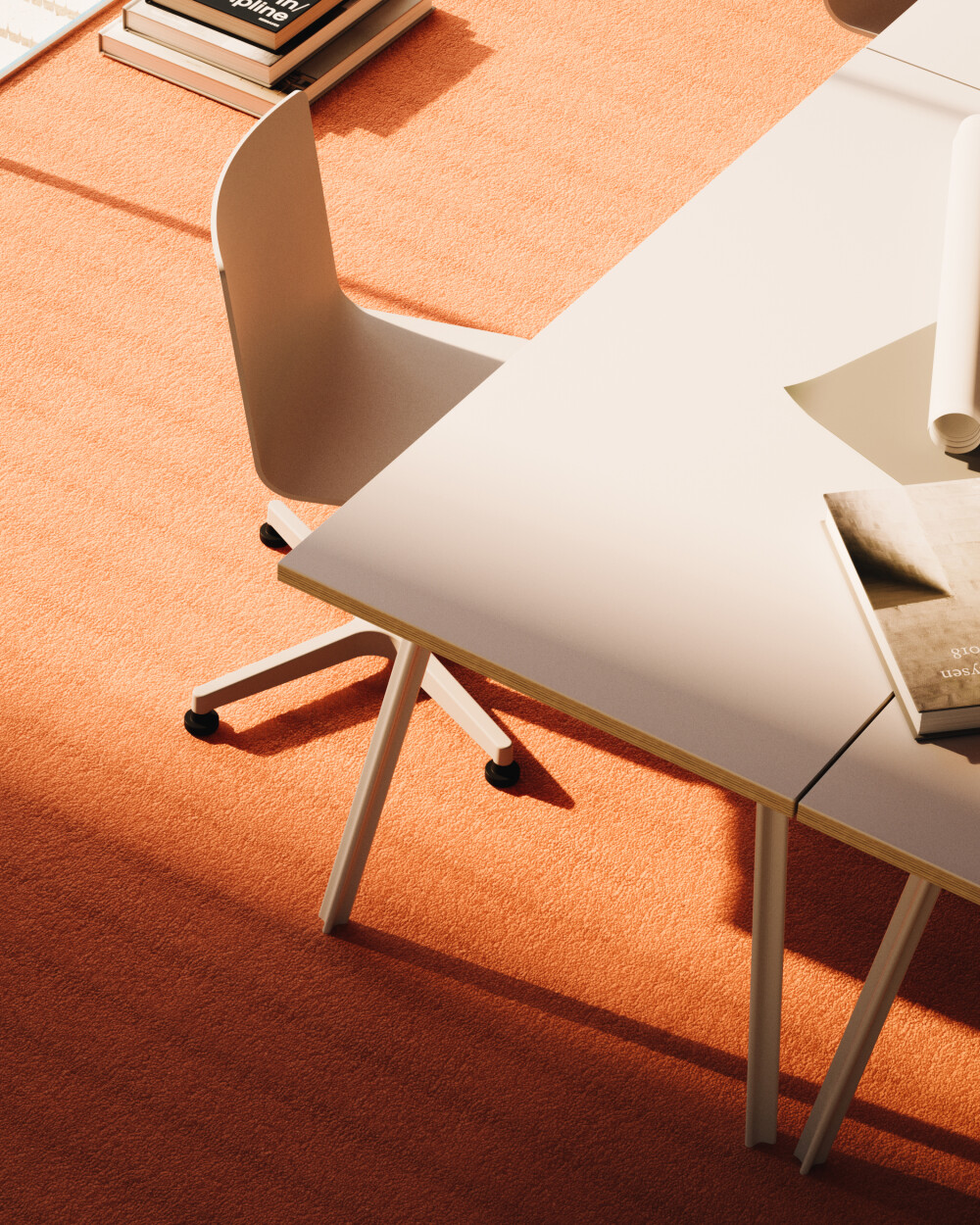 Close-up of a light pink Beam desk with a light-colored frame, focusing on the edge of the table and the leg in a modern office setting