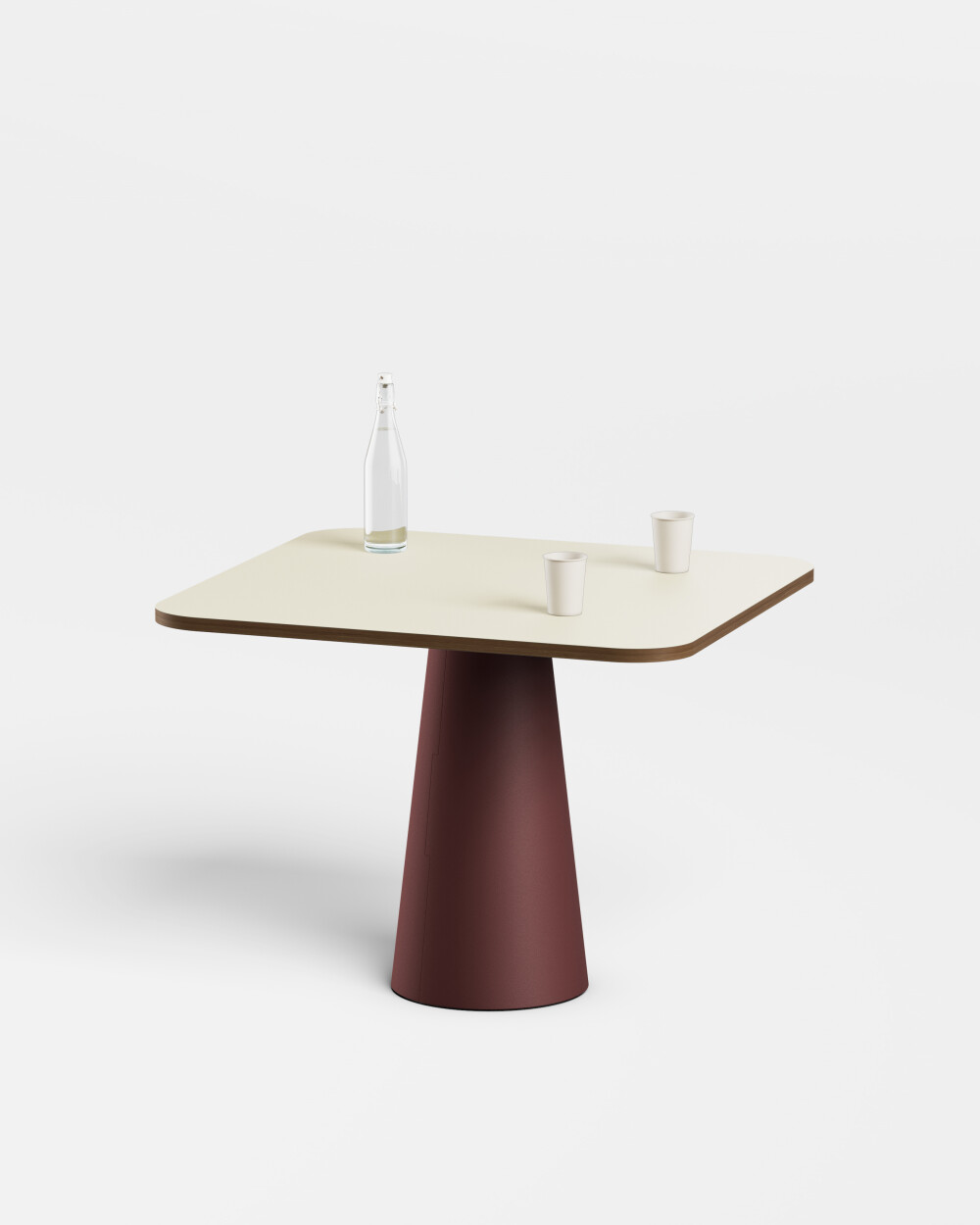Square ALT table by Faust with cream-coloured top and conical red base, with a bottle and glasses on top.