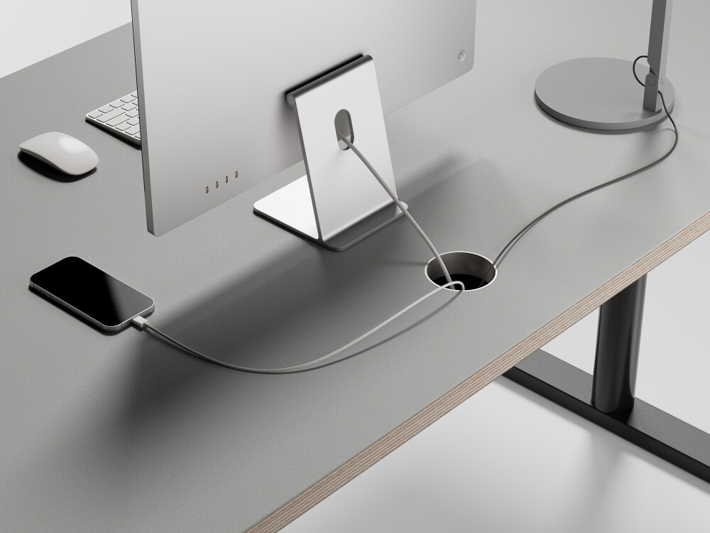 Grey ATS desk with round cable outlet for tidy routing of monitor and charging cables through the tabletop.