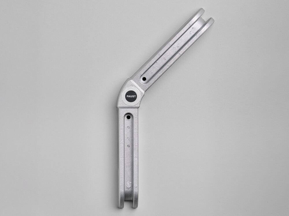 Top view of L-connector by Faust, made of metal, used as a connecting element for the modular construction of the Outline table system.