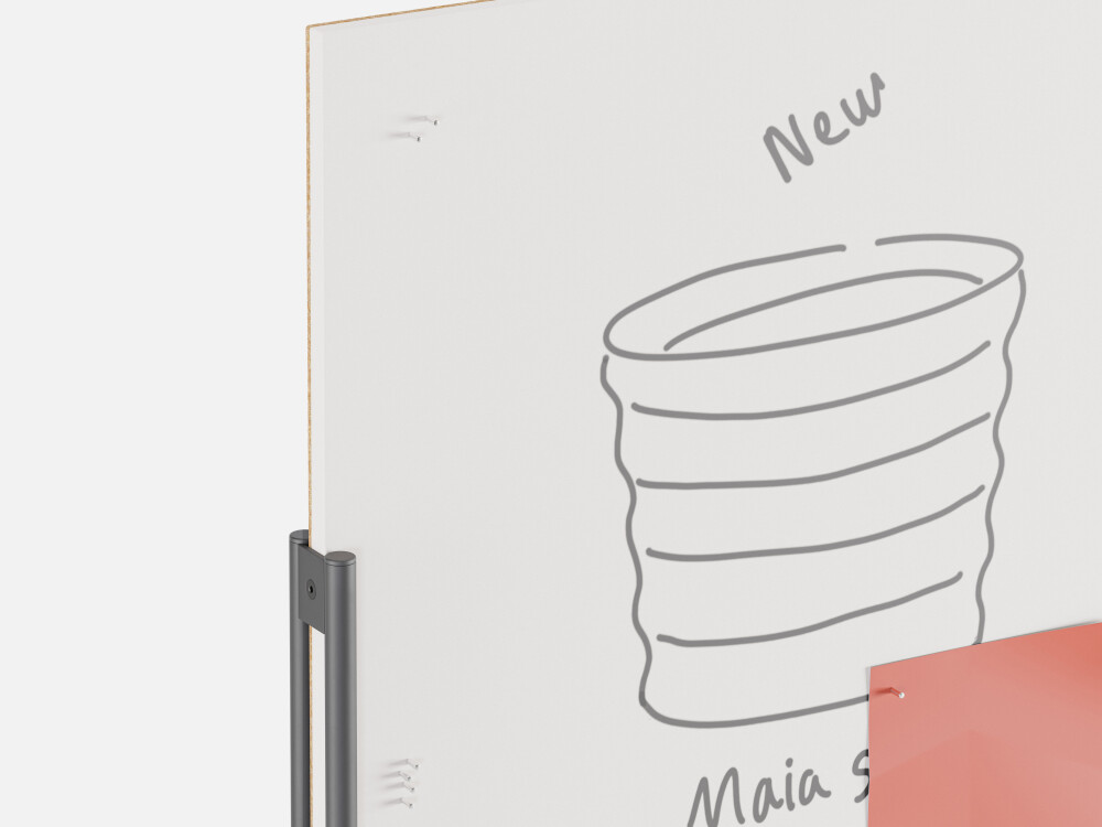 Detailed view of the WALL pinboard with a white surface, featuring a drawing of a vessel and small magnets.