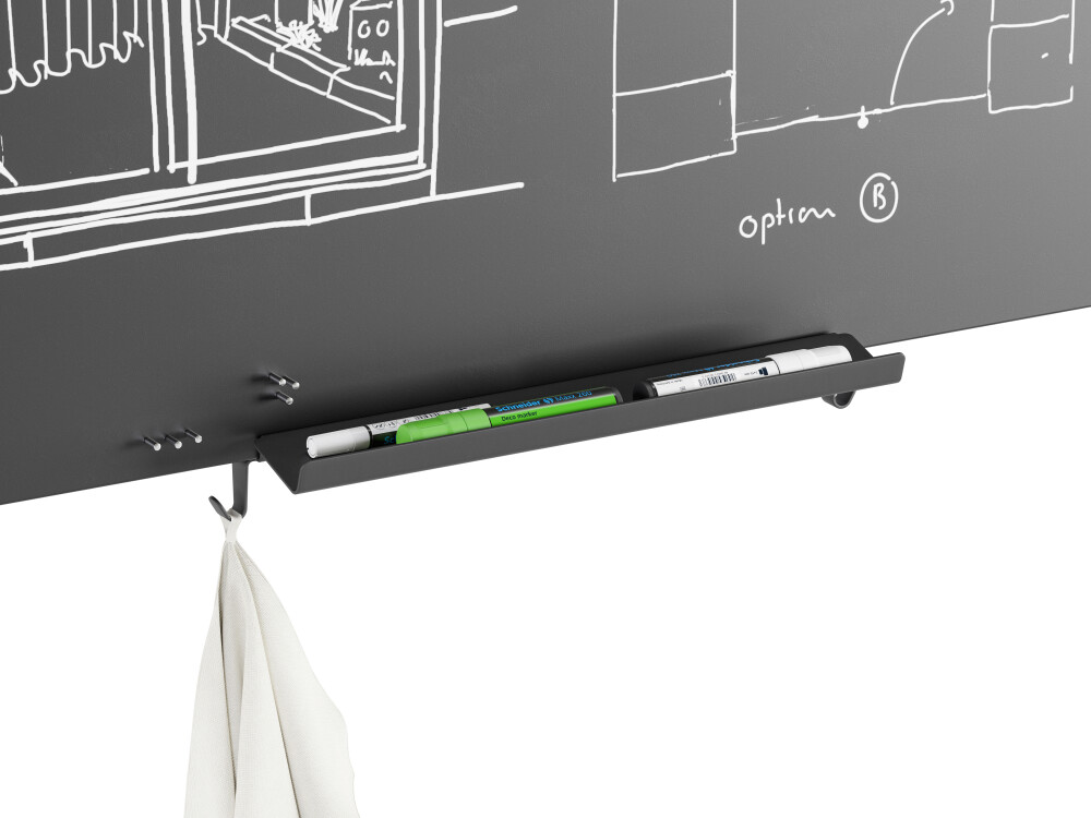 Detailed view of the WALL notice board in black with storage for markers and hooks with a cloth hanging from them.