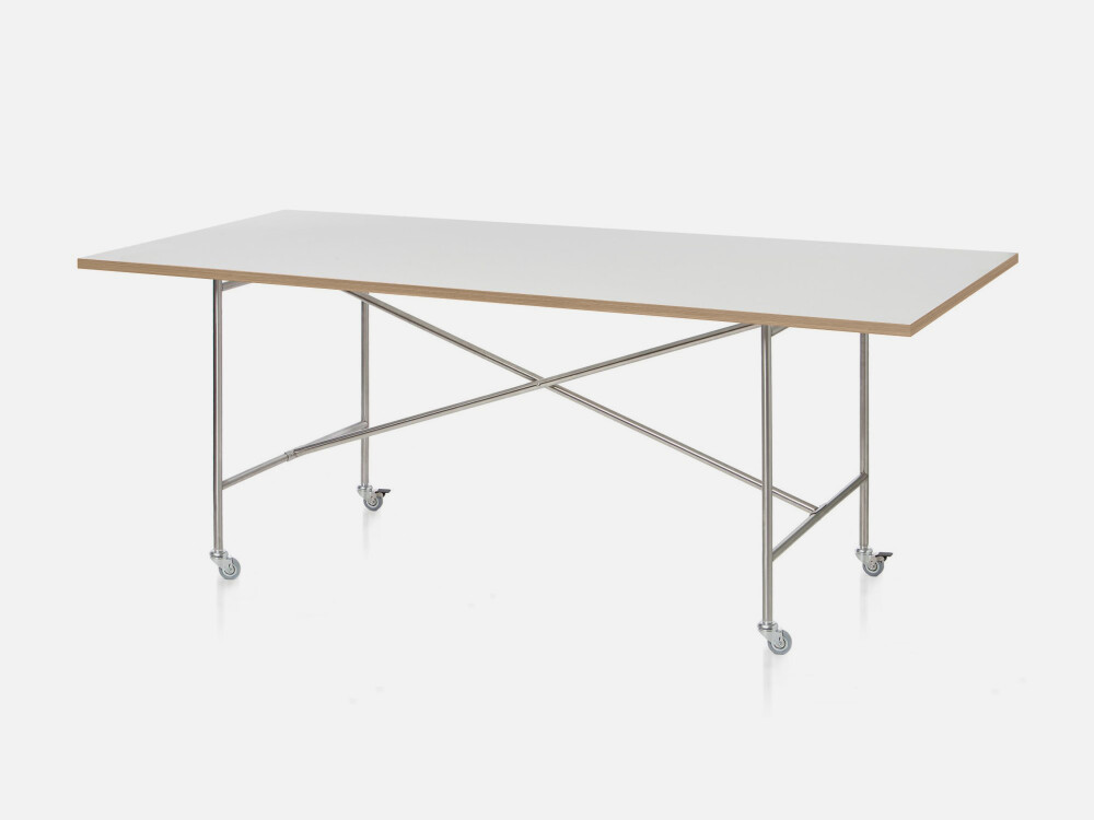 E2 table with white top and cross-brace frame on swivel casters – ideal for mobile work environments.